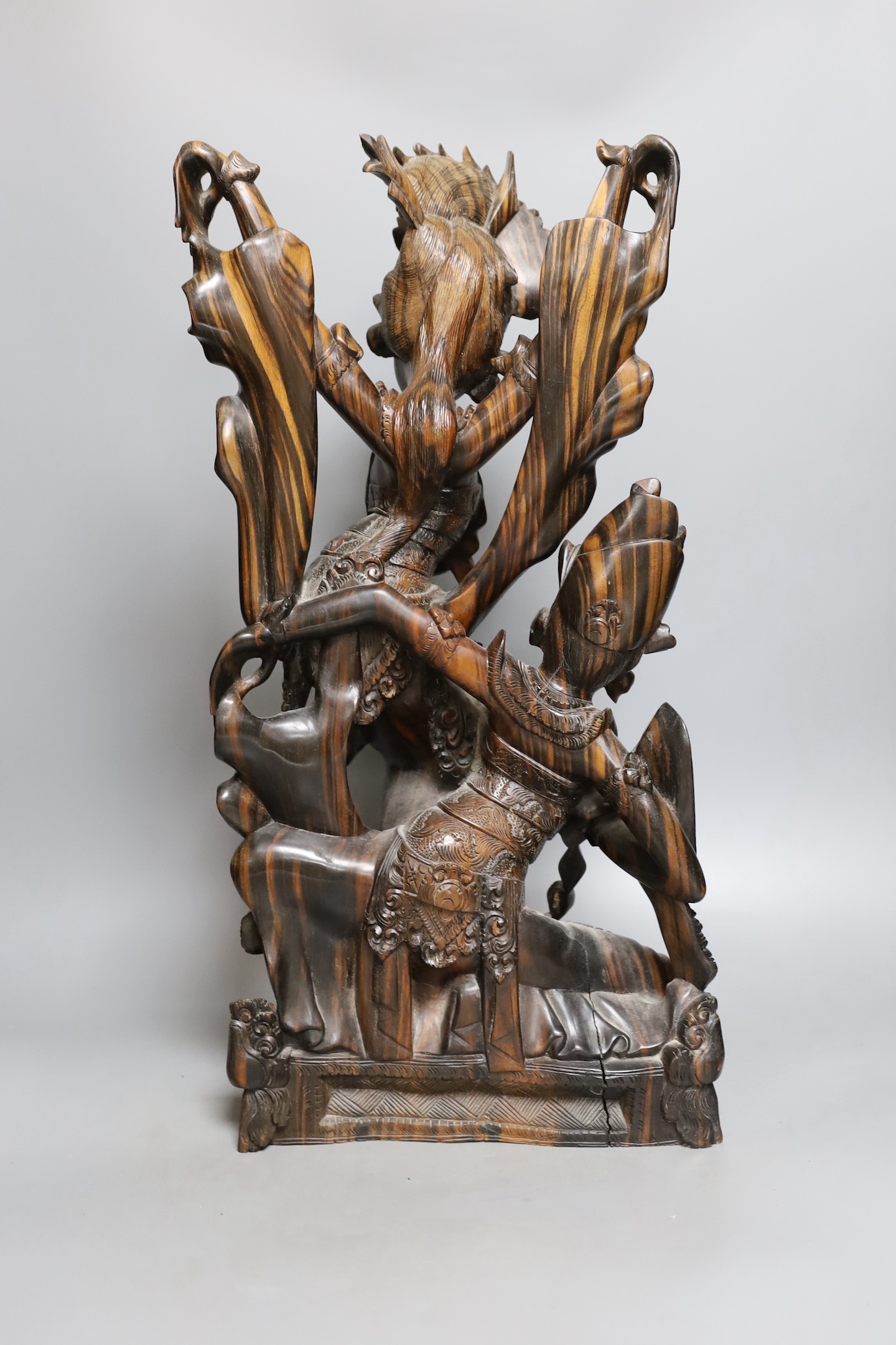 A Balinese carved coromandel deity group , 50 cms high.